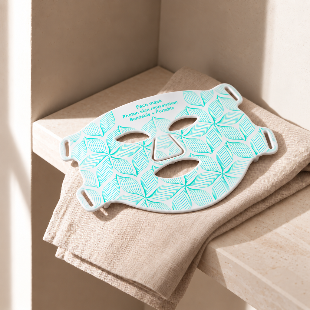 Aurora Light Mask in white resting on folded linen in a stone niche