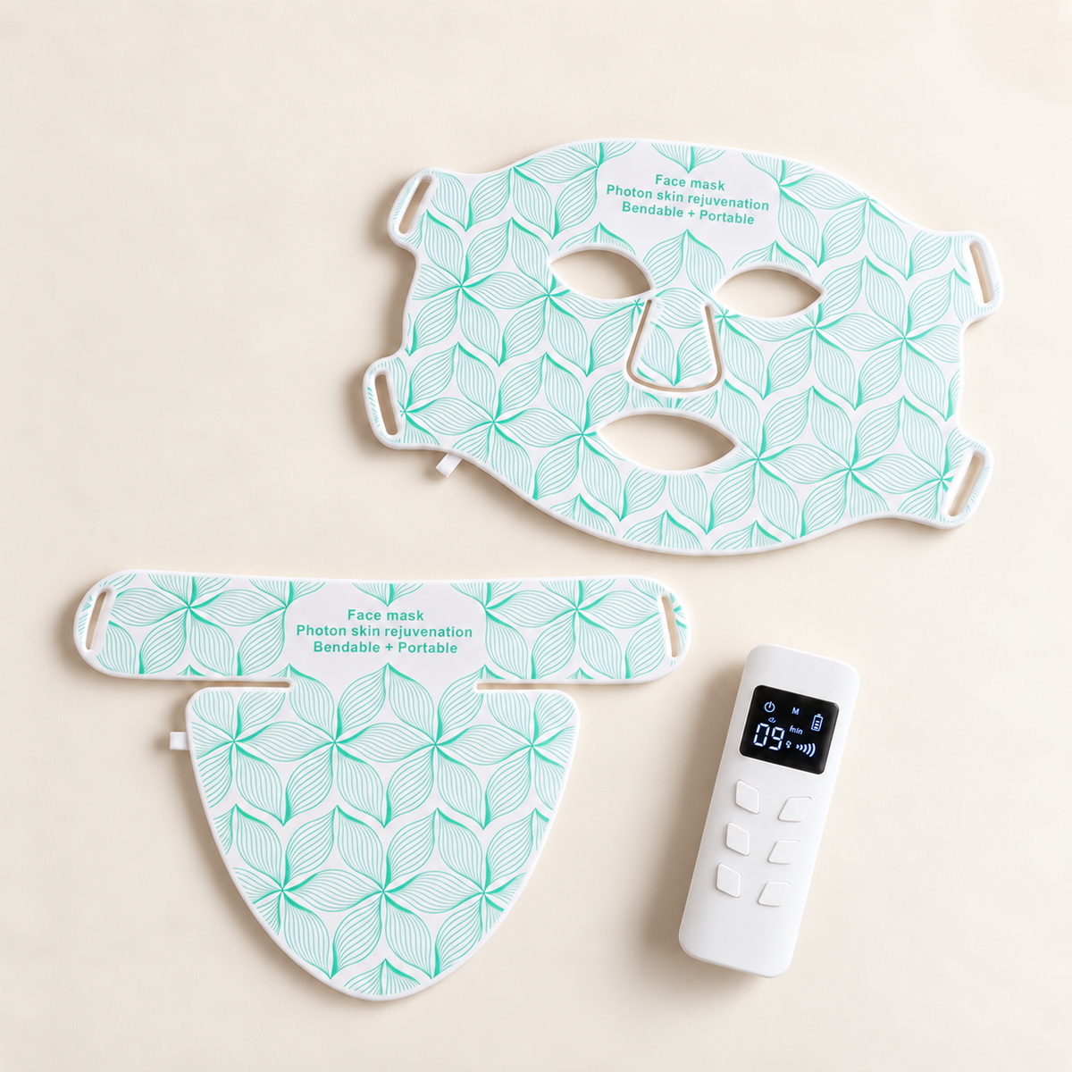 Aurora Light Mask in white: face mask, neck and decollete piece and remote control laid out on a cream background