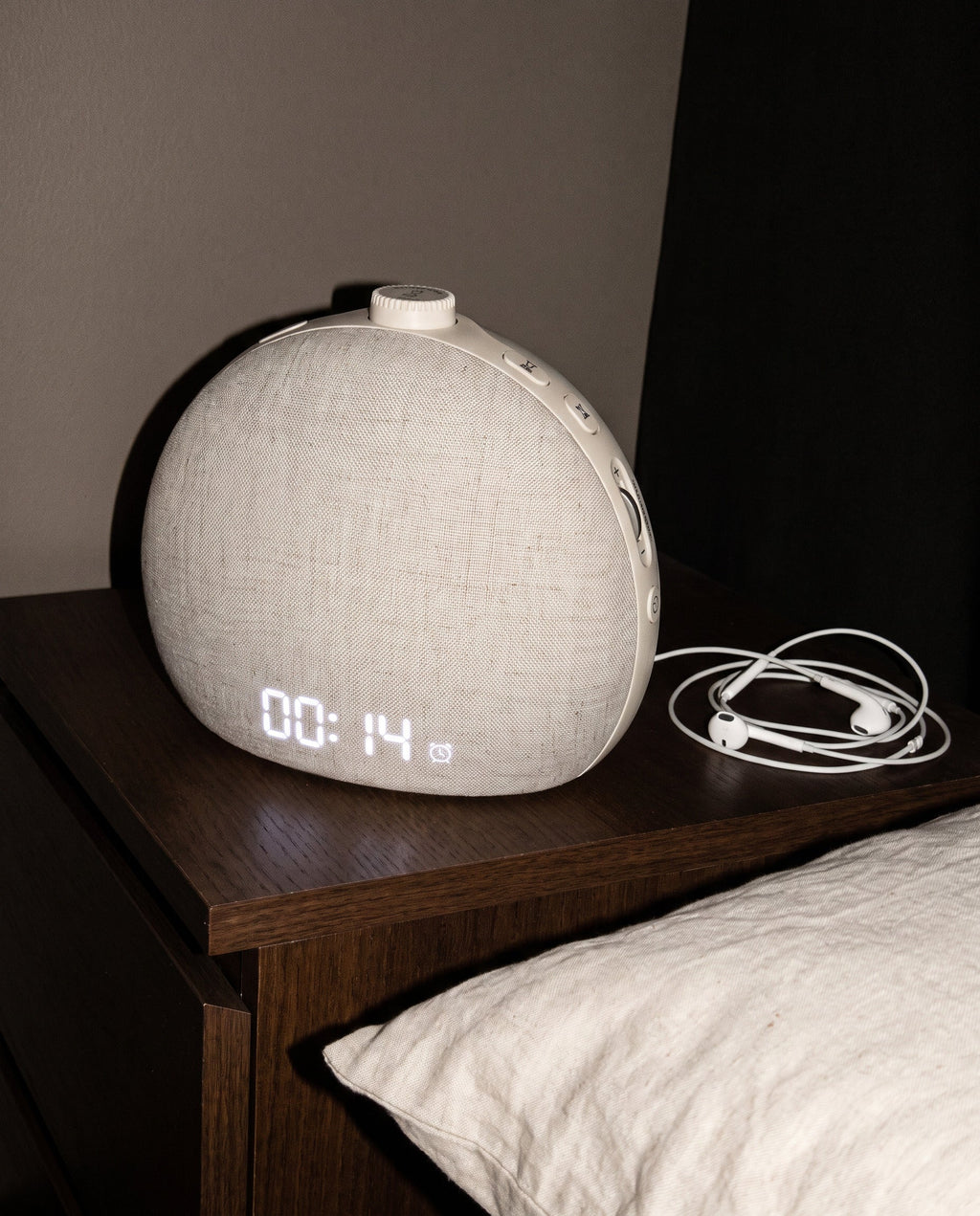 Halcyon wake-up light on a bedside table at night, display reading 00:14, side controls visible