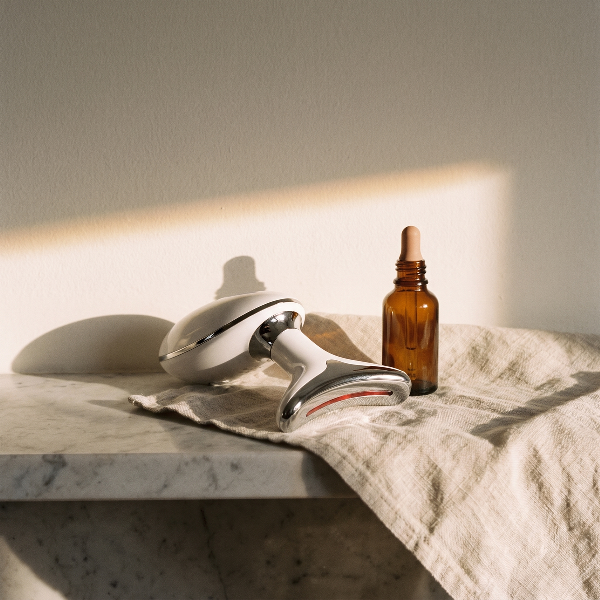 The Contour device resting on linen on a marble shelf in morning light