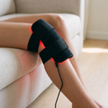 The Ember red light pad wrapped against a bare knee, diodes against the skin